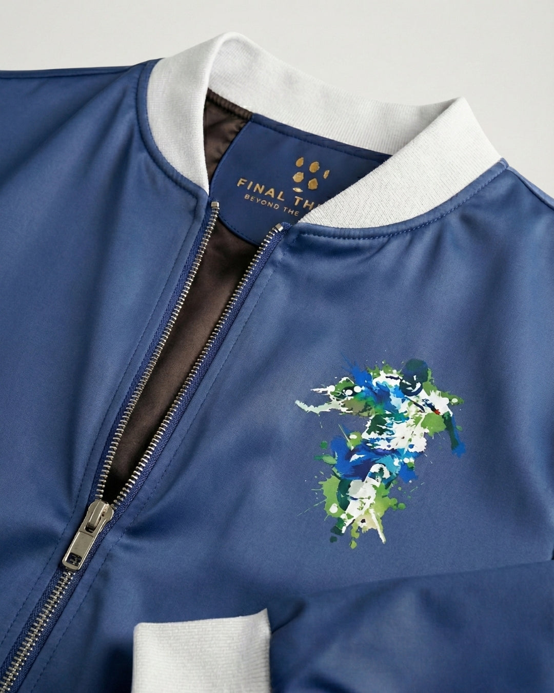 Blue jacket with floral design and brand logo on a light gray background