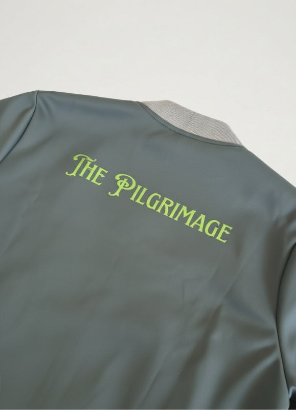 Gray jacket with 'The Pilgrimage' text on a light gray background